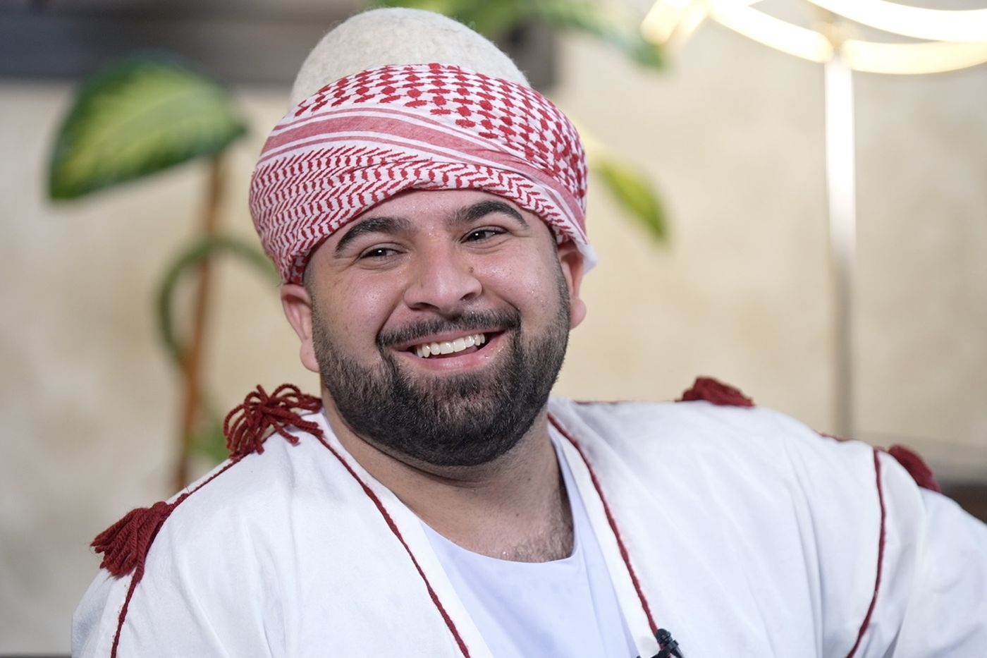 Young man in traditional Iraqi dress smiling