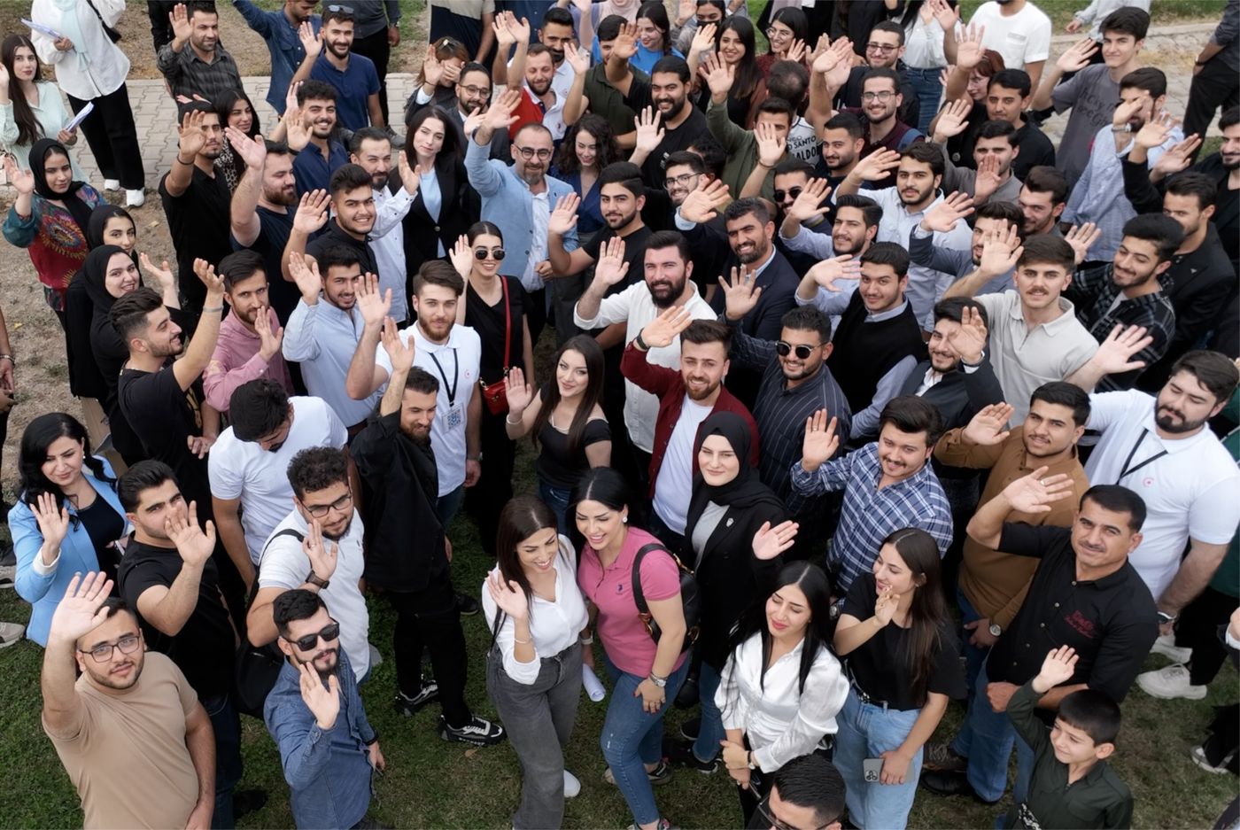 Crowd of young people waving